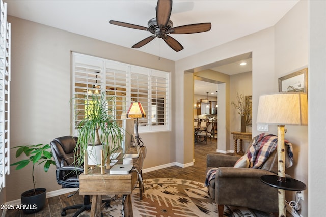 sitting room with ceiling fan, wood finished floors, and baseboards