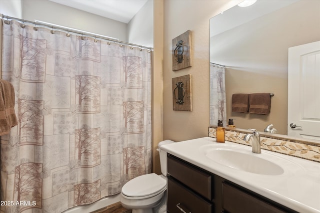 bathroom featuring toilet, a shower with curtain, and vanity