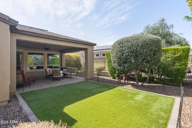 view of yard featuring ceiling fan, a patio, fence, and an outdoor living space