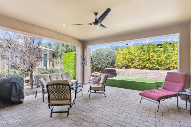 view of patio with outdoor lounge area, ceiling fan, grilling area, and fence