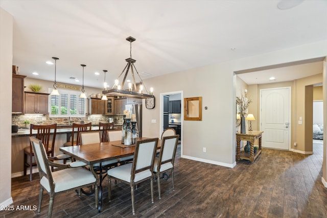 dining room featuring a notable chandelier, dark wood-style flooring, recessed lighting, and baseboards