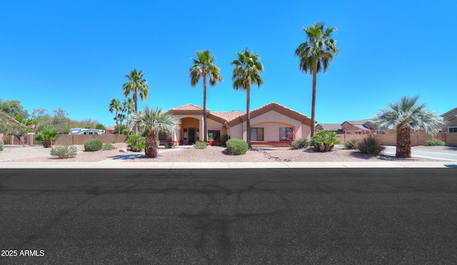 380 E Wiley Way, Casa Grande, AZ 85122 - mediterranean / spanish-style house with stucco siding, fence, and a tiled roof