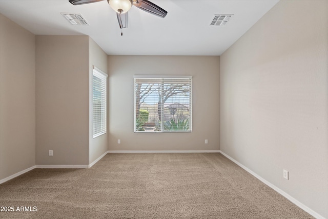 unfurnished room featuring carpet floors, visible vents, and a ceiling fan