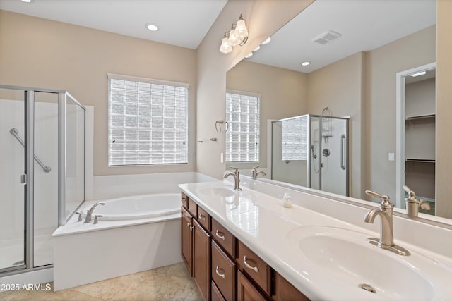 full bathroom featuring a garden tub, a stall shower, a sink, and visible vents