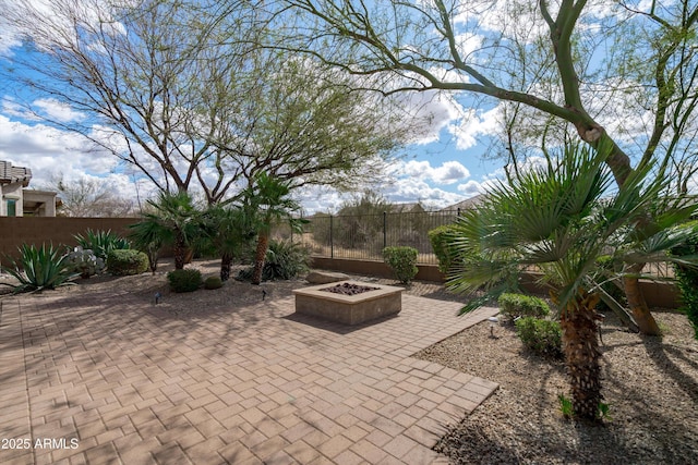 view of patio / terrace featuring a fire pit and fence private yard