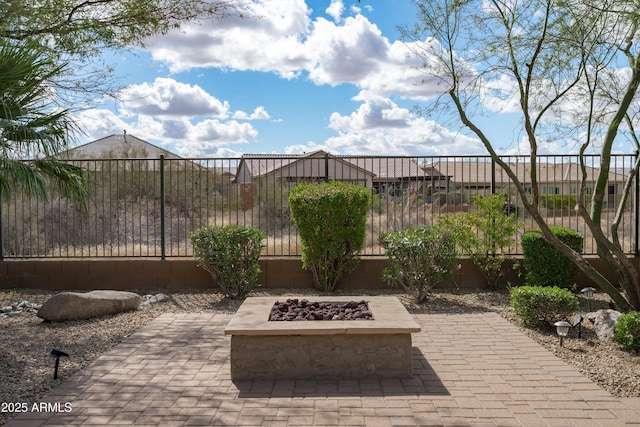 view of patio featuring an outdoor fire pit and fence