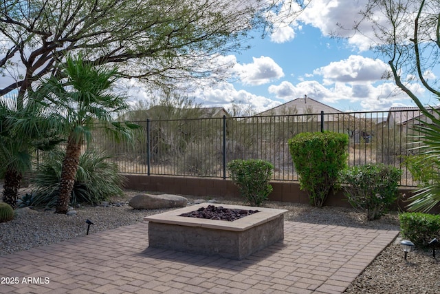 view of patio featuring fence and a fire pit