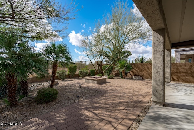 view of patio / terrace with an outdoor fire pit and a fenced backyard