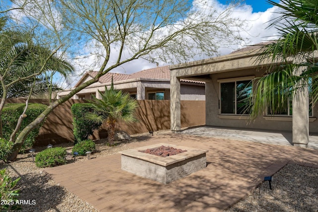 view of patio featuring an outdoor fire pit and a fenced backyard