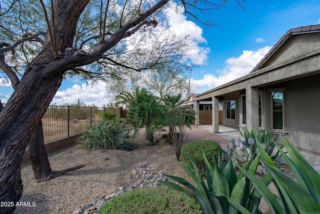 view of yard with a patio and fence