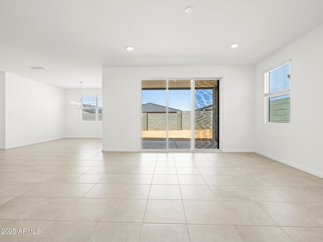 4032 S 176th Dr, Goodyear, AZ 85338 - spare room featuring a chandelier, healthy amount of natural light, light tile patterned floors, and recessed lighting