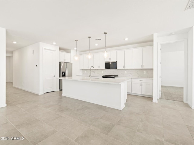 4032 S 176th Dr, Goodyear, AZ 85338 - kitchen with stainless steel appliances, light countertops, recessed lighting, tasteful backsplash, and white cabinetry