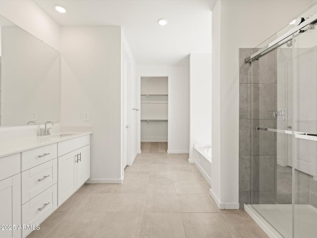 4032 S 176th Dr, Goodyear, AZ 85338 - bathroom featuring vanity, a stall shower, a bath, recessed lighting, and tile patterned flooring