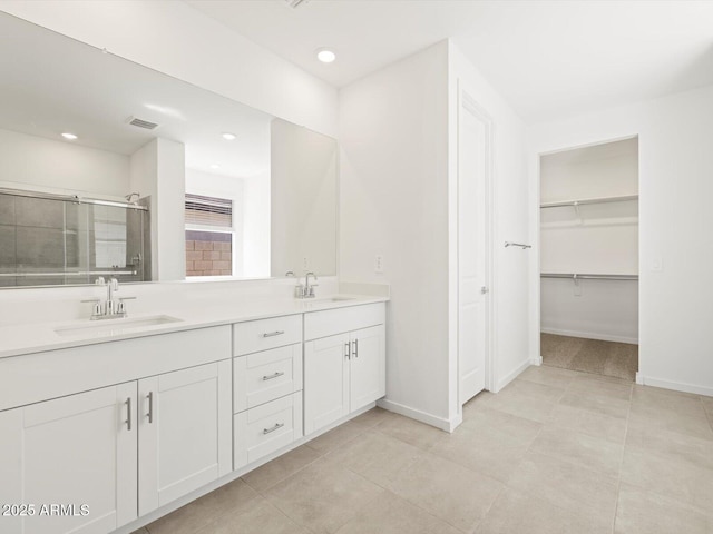 4032 S 176th Dr, Goodyear, AZ 85338 - full bath featuring double vanity, a stall shower, recessed lighting, tile patterned flooring, and a walk in closet