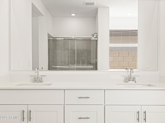 4032 S 176th Dr, Goodyear, AZ 85338 - full bathroom with double vanity, recessed lighting, and a tile shower