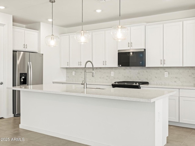 4032 S 176th Dr, Goodyear, AZ 85338 - kitchen featuring stainless steel appliances, an island with sink, recessed lighting, backsplash, and light countertops
