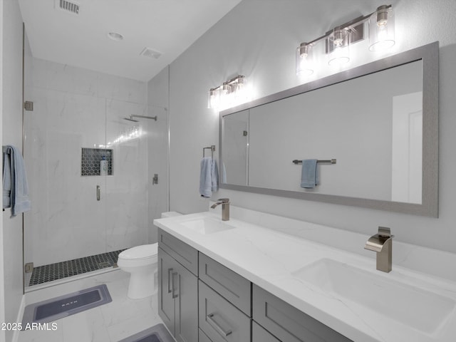 bathroom with a marble finish shower, marble finish floor, a sink, and toilet