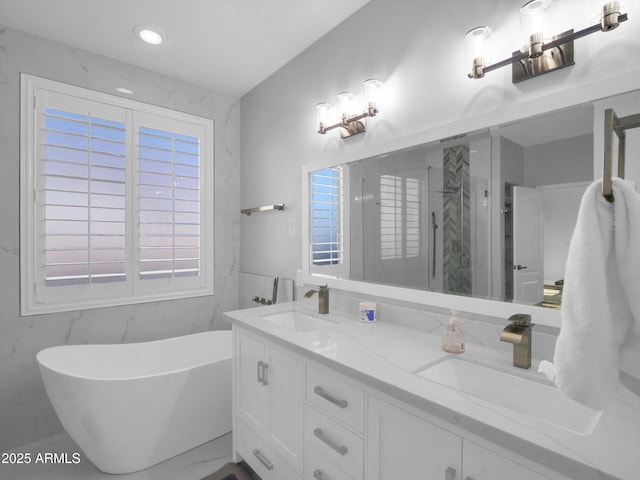 bathroom featuring double vanity, marble finish floor, a marble finish shower, and a sink