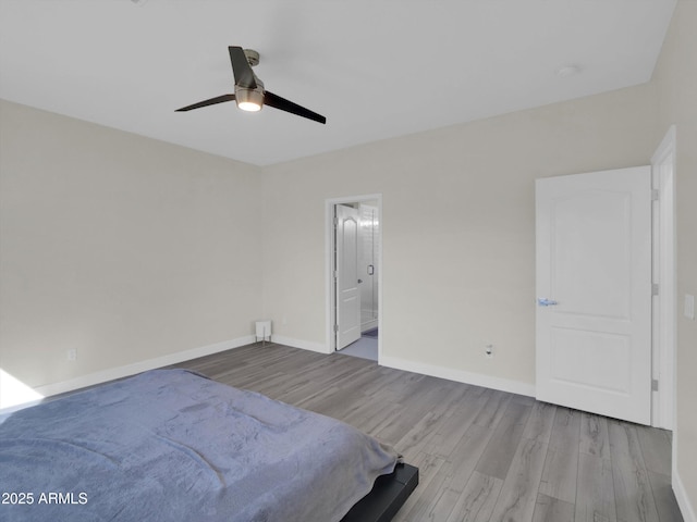 unfurnished bedroom with ensuite bathroom, ceiling fan, baseboards, and wood finished floors