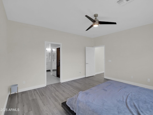 bedroom featuring baseboards, visible vents, a ceiling fan, wood finished floors, and ensuite bathroom