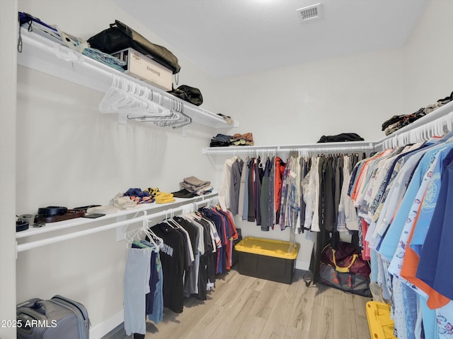 spacious closet featuring visible vents and wood finished floors