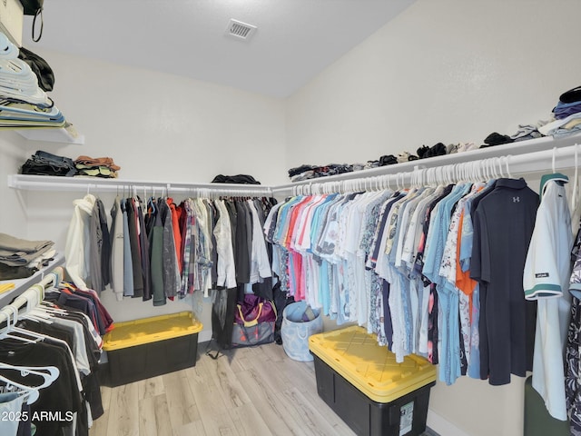 walk in closet with visible vents and wood finished floors