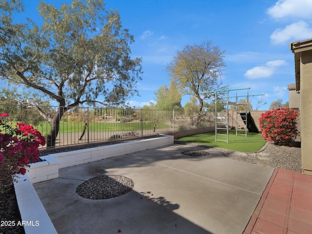 view of patio with fence and a playground