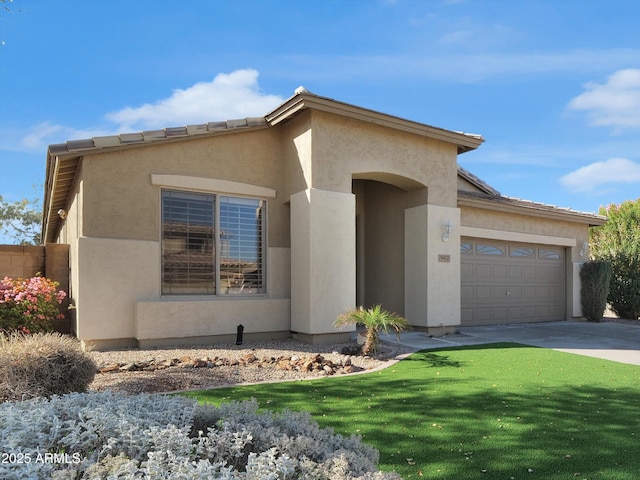 view of front facade with an attached garage, a front yard, concrete driveway, and stucco siding