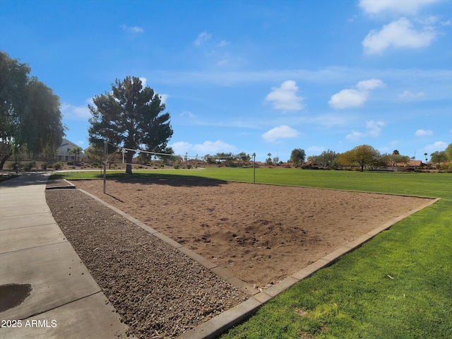 view of community with a lawn and volleyball court