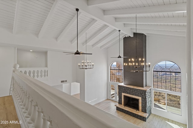 hallway featuring a notable chandelier, high vaulted ceiling, light hardwood / wood-style floors, and beamed ceiling