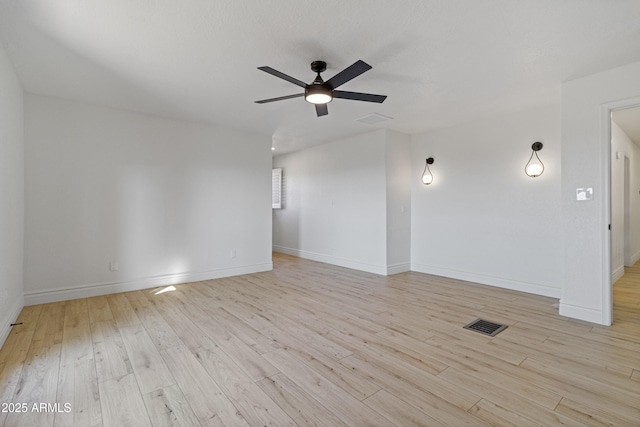 spare room with light hardwood / wood-style floors and ceiling fan