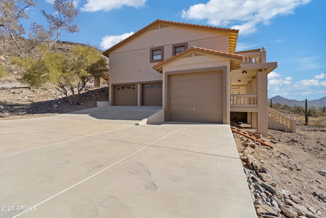 mediterranean / spanish home featuring a mountain view and a garage