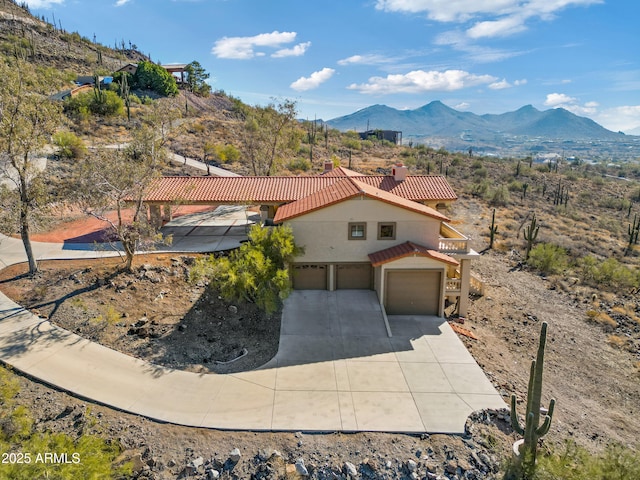 exterior space with a garage and a mountain view