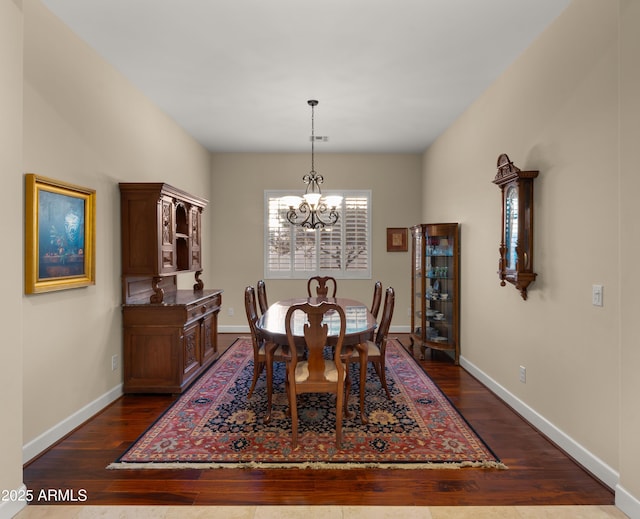 17755 E Colt Dr, Queen Creek, AZ 85142 - dining space with a chandelier, dark wood-style floors, and baseboards