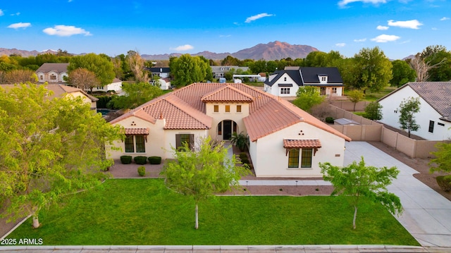 17755 E Colt Dr, Queen Creek, AZ 85142 - mediterranean / spanish-style home featuring a front lawn, a tile roof, concrete driveway, stucco siding, and a mountain view