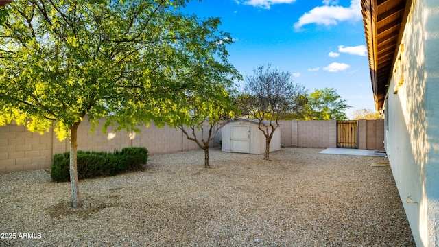 17755 E Colt Dr, Queen Creek, AZ 85142 - view of yard featuring a gate, a storage unit, a fenced backyard, and an outdoor structure