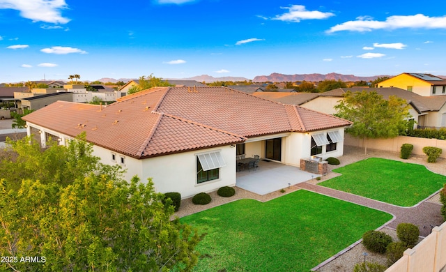 17755 E Colt Dr, Queen Creek, AZ 85142 - rear view of house featuring a tile roof, a patio area, a lawn, and a fenced backyard