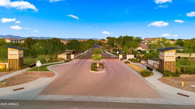 17755 E Colt Dr, Queen Creek, AZ 85142 - view of home's community featuring a gate, a mountain view, and curved driveway