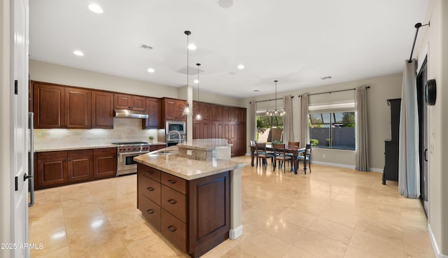 17755 E Colt Dr, Queen Creek, AZ 85142 - kitchen featuring a kitchen island with sink, a sink, stainless steel appliances, under cabinet range hood, and backsplash