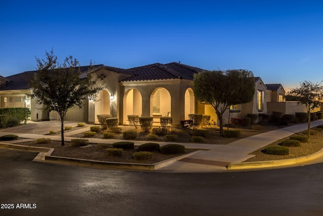 mediterranean / spanish-style house with a garage