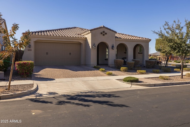 mediterranean / spanish-style house with a garage