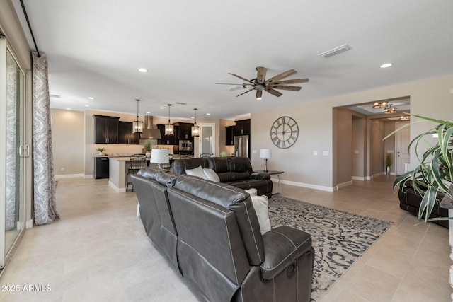 tiled living room with ceiling fan