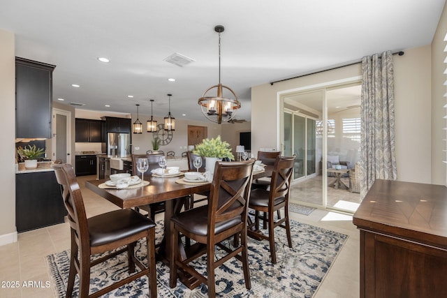 tiled dining area with a chandelier