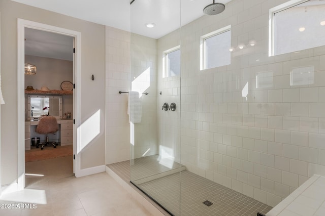 bathroom with tile patterned flooring and a tile shower