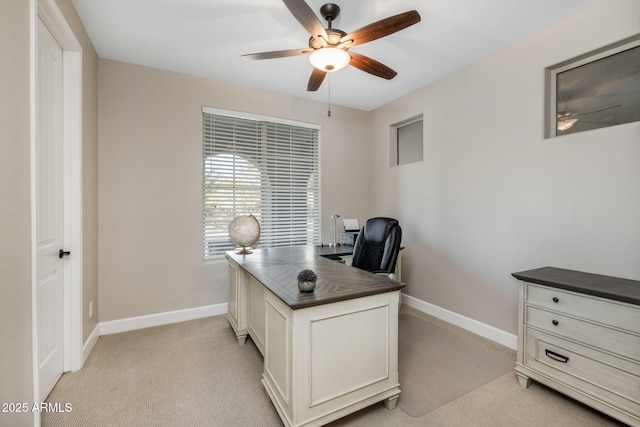 carpeted office featuring ceiling fan