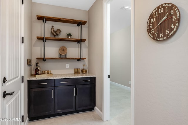 bar featuring light stone countertops