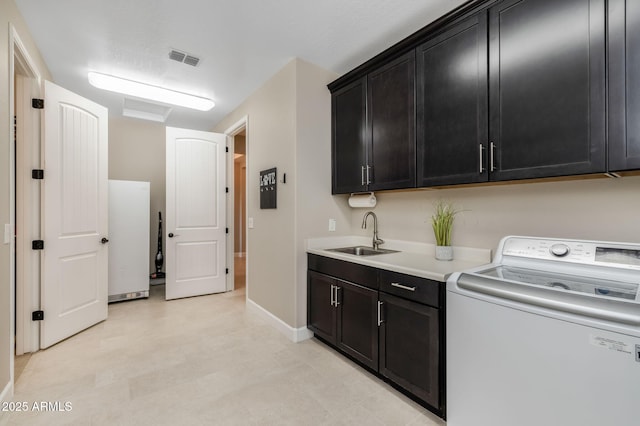 laundry room with washer / dryer, sink, and cabinets