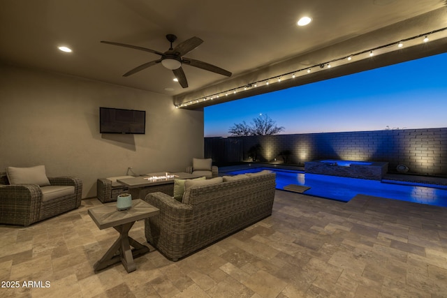 view of patio with an outdoor living space with a fire pit and an in ground hot tub