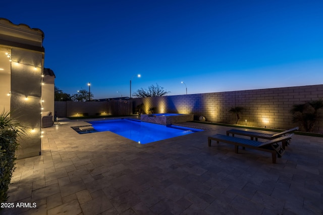 pool at dusk featuring a patio, cooling unit, and an in ground hot tub