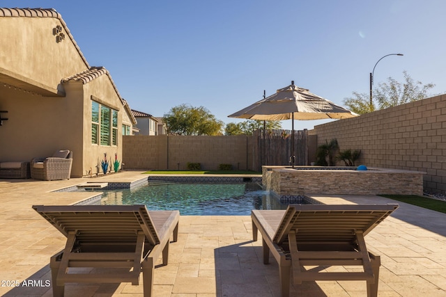 view of pool featuring pool water feature and a patio